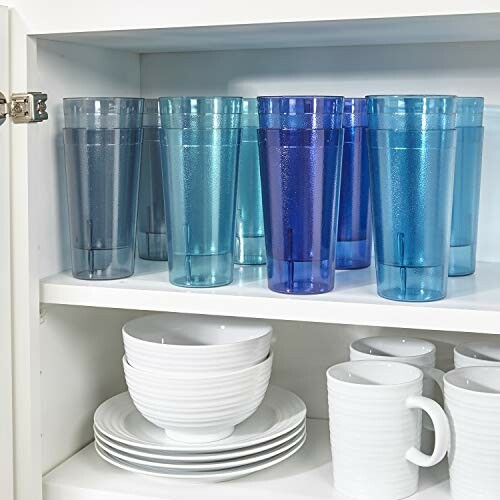 Blue and clear tumblers with white dishes in a cabinet