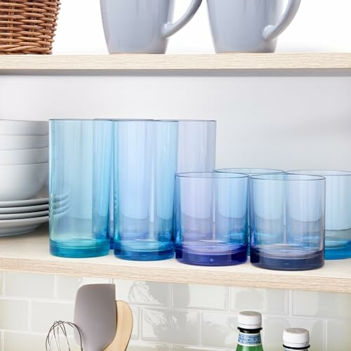 Blue glassware and mugs on a kitchen shelf