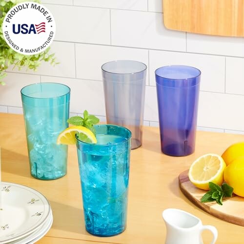 Colorful drinking glasses with lemons on a kitchen counter.