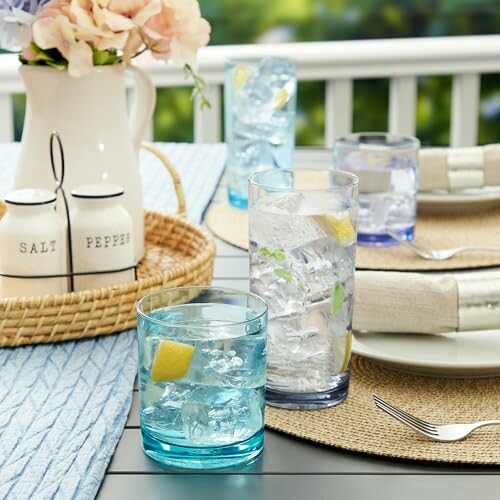 Outdoor table setting with drinks and flowers