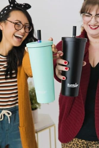 Two women holding colorful tumblers